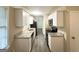 The remodeled kitchen showcases sleek, white cabinets, stainless steel appliances, and granite countertops at 5219 Maple Valley Sw Rd, Mableton, GA 30126