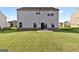 Expansive backyard featuring a lush green lawn and a sliding glass door for easy access to the home at 838 Maduro Way, Mcdonough, GA 30253