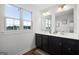 Modern bathroom with a double vanity, dark cabinets, and a large window providing natural light at 838 Maduro Way, Mcdonough, GA 30253