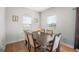 Cozy dining room with a modern table, comfortable chairs, and natural light from the windows at 838 Maduro Way, Mcdonough, GA 30253