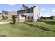 Inviting two-story home with a well-manicured front yard and a charming tree, enhancing curb appeal at 838 Maduro Way, Mcdonough, GA 30253