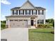 Charming two-story home featuring a gray exterior, black shutters, and a spacious two-car garage at 838 Maduro Way, Mcdonough, GA 30253