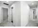 Bright hallway with neutral carpet and paint, featuring several doorways and ample lighting at 838 Maduro Way, Mcdonough, GA 30253
