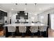 Stunning kitchen featuring dark cabinets, stainless steel appliances, and granite countertops with barstool seating at 838 Maduro Way, Mcdonough, GA 30253