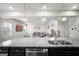Kitchen area leading to a living room featuring granite countertops and modern fixtures at 838 Maduro Way, Mcdonough, GA 30253