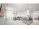 Bright living room featuring plush gray sectional sofa and a large flat-screen television at 838 Maduro Way, Mcdonough, GA 30253
