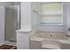 Bright bathroom featuring a soaking tub, tiled walls, and glass-enclosed shower at 325 Espana St, South Fulton, GA 30349