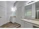 Bathroom with double sinks, mirrors, and wood-look floors for a luxurious feel at 325 Espana St, South Fulton, GA 30349
