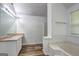 Bathroom featuring a soaking tub, vanity with sink, and wood-look flooring at 325 Espana St, South Fulton, GA 30349