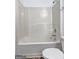 Clean bathroom features an integrated white tub and shower combination with chrome fixtures at 325 Espana St, South Fulton, GA 30349