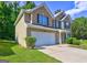 Two-story brick home with attached garage, well-kept lawn, and mature landscaping at 325 Espana St, South Fulton, GA 30349