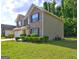 Brick home with a well-maintained lawn and landscaped shrubbery at 325 Espana St, South Fulton, GA 30349