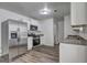 White kitchen featuring stainless steel appliances, granite countertops and updated cabinetry at 325 Espana St, South Fulton, GA 30349