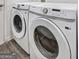 Laundry room featuring a white, front-loading Samsung washer and dryer set at 325 Espana St, South Fulton, GA 30349