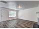 Bright living room with a door to the front porch and updated flooring at 325 Espana St, South Fulton, GA 30349