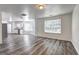 Open-concept living room connecting to kitchen with updated flooring and neutral colors at 325 Espana St, South Fulton, GA 30349