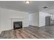 Spacious living room with fireplace, access to the kitchen, and modern gray flooring at 325 Espana St, South Fulton, GA 30349
