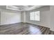 Inviting main bedroom with decorative tray ceiling, bright window, and a private entrance to ensuite bathroom at 325 Espana St, South Fulton, GA 30349