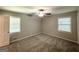 Bright, carpeted bedroom with two windows and a ceiling fan at 4313 Executive Dr, Stone Mountain, GA 30083