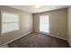 Bedroom with carpeted floors, two windows, and neutral paint at 4313 Executive Dr, Stone Mountain, GA 30083