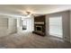 Spacious living room with a brick fireplace and built-in shelving at 4313 Executive Dr, Stone Mountain, GA 30083