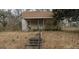 Modest one-story home with a covered front porch needing some landscape and repair at 224 Fayetteville Rd, Palmetto, GA 30268