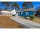 Backyard with a concrete driveway and a blue house exterior at 2584 Oldknow Nw Dr, Atlanta, GA 30318