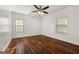 Bright bedroom featuring hardwood floors, a ceiling fan, and two windows at 2584 Oldknow Nw Dr, Atlanta, GA 30318