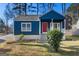 Charming blue home with a red front door and a cozy front porch at 2584 Oldknow Nw Dr, Atlanta, GA 30318