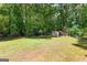 Large backyard features a shed and mature trees at 224 Claridge Curv, Peachtree City, GA 30269