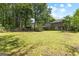 Large backyard with mature trees and partial view of the home at 224 Claridge Curv, Peachtree City, GA 30269