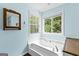Bright bathroom with soaking tub, wood-look floors, and views to the yard at 224 Claridge Curv, Peachtree City, GA 30269