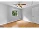 Bedroom features light hardwood floors and a window with wooded views at 224 Claridge Curv, Peachtree City, GA 30269