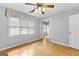 Spacious bedroom with hardwood floors, ceiling fan, and two windows at 224 Claridge Curv, Peachtree City, GA 30269