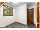 Spacious bedroom with a window letting in natural light and tiled flooring at 224 Claridge Curv, Peachtree City, GA 30269