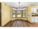 Bright dining area features a bay window, modern chandelier, and wood-look floors at 224 Claridge Curv, Peachtree City, GA 30269