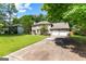 Traditional home featuring a long driveway and a manicured front lawn at 224 Claridge Curv, Peachtree City, GA 30269
