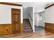 Hallway featuring a staircase, carpet, front door, and wood trim at 224 Claridge Curv, Peachtree City, GA 30269