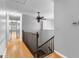 Hallway with hardwood floors, stairwell, and ceiling fan at 224 Claridge Curv, Peachtree City, GA 30269