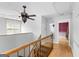 Upstairs hallway featuring a ceiling fan, stair railing, and mirror at 224 Claridge Curv, Peachtree City, GA 30269