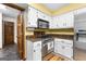 Updated kitchen features stainless steel appliances, granite countertops, and white cabinetry at 224 Claridge Curv, Peachtree City, GA 30269