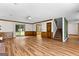 Open living room with wood-look floors, staircase, and sliding glass door to outdoor space at 224 Claridge Curv, Peachtree City, GA 30269