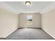 This carpeted bedroom offers natural light with a window view of the neighborhood at 5669 Blackberry Row, Ellenwood, GA 30294