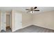 This bedroom features neutral walls, new carpet, a ceiling fan, and a standard closet at 5669 Blackberry Row, Ellenwood, GA 30294