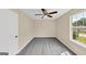 Cozy bedroom featuring neutral walls, plush carpeting, a ceiling fan, and a window for natural light at 5669 Blackberry Row, Ellenwood, GA 30294