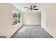 This spacious bedroom is bright with a large window and a ceiling fan for comfort at 5669 Blackberry Row, Ellenwood, GA 30294
