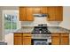 Updated kitchen featuring granite countertops, modern appliances, and wooden cabinets at 5669 Blackberry Row, Ellenwood, GA 30294