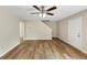 Spacious living area with wood-look flooring, ceiling fan, and a staircase leading to the upper level at 5669 Blackberry Row, Ellenwood, GA 30294
