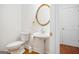 Charming half-bathroom with pedestal sink, gold mirror, and tile floors at 225 S South Shore Ter, Fayetteville, GA 30214