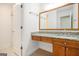Main bathroom vanity featuring granite counters, wood cabinets and a large mirror at 225 S South Shore Ter, Fayetteville, GA 30214